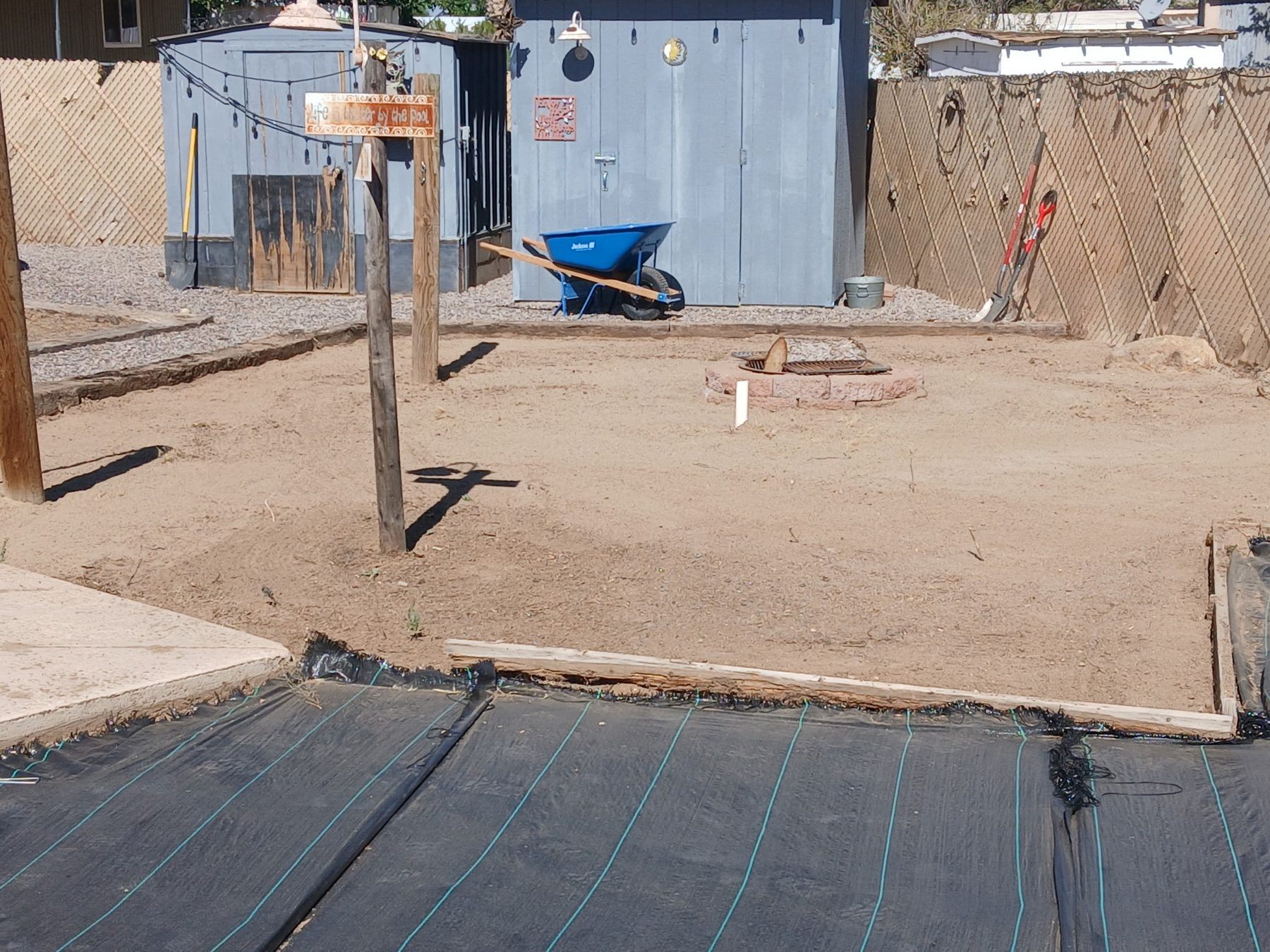 Yard prepared for rock and landscape fabric installation