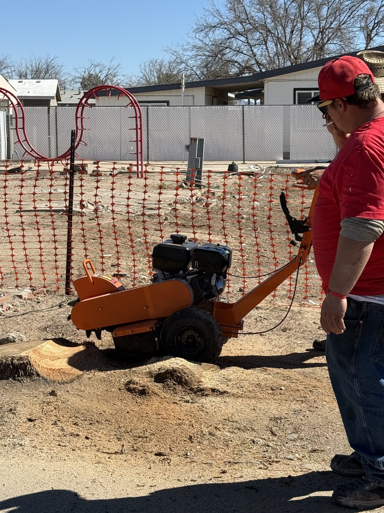 Stump grinder making a pass over an old stump